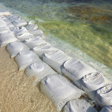 sandbags in rows at the water s edge to prevent er 2022 03 04 02 32 49 utc